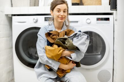 Portrait of a happy young housewife with clean clothes